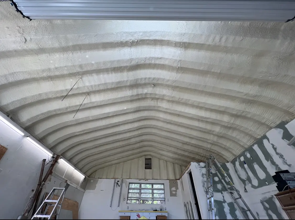 Spray polyurethane foam applied to the underside of a metal roof deck in Brent